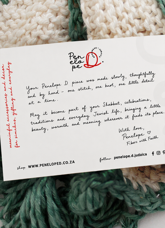 Handwritten Penelope D thank-you card resting on a cream-coloured challah cover